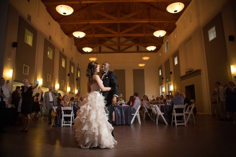 bride and groom dance in front of seated guests