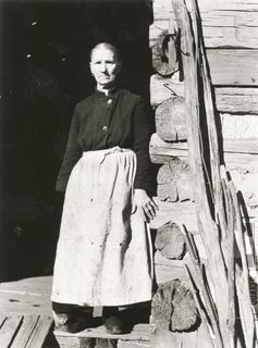 A black and white photo of a woman in a dress