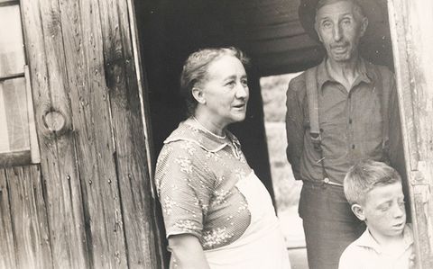 A black and white photo of a man, woman, and child